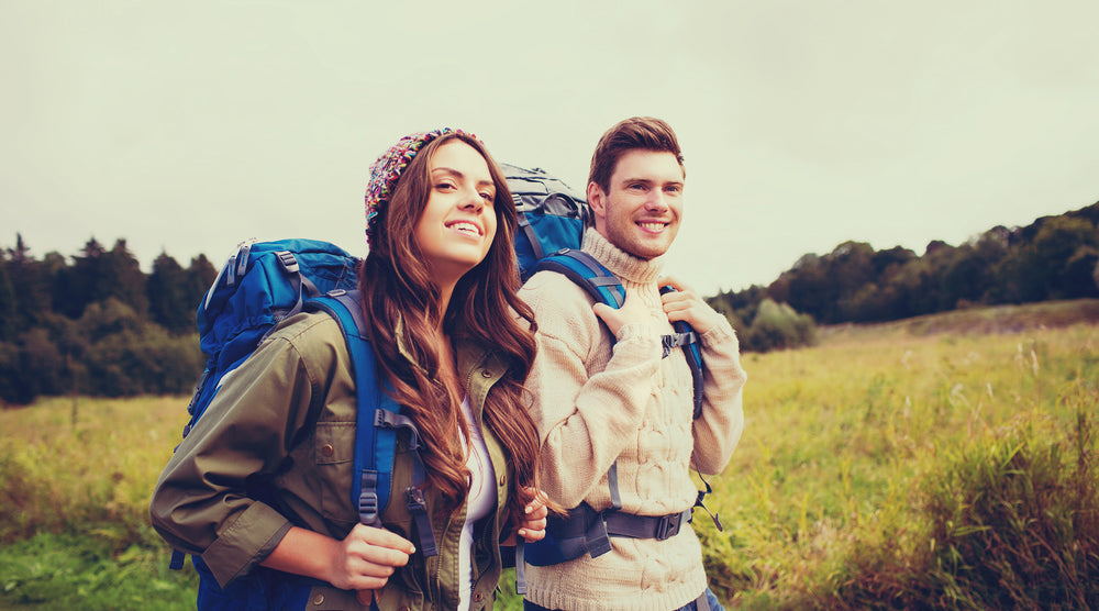 Woman and man hiking using sun protection pill