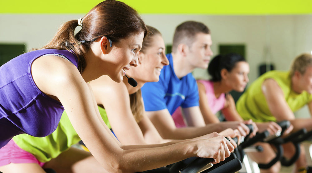 Stationary Bicycle Group Fitness Class With Women And Men