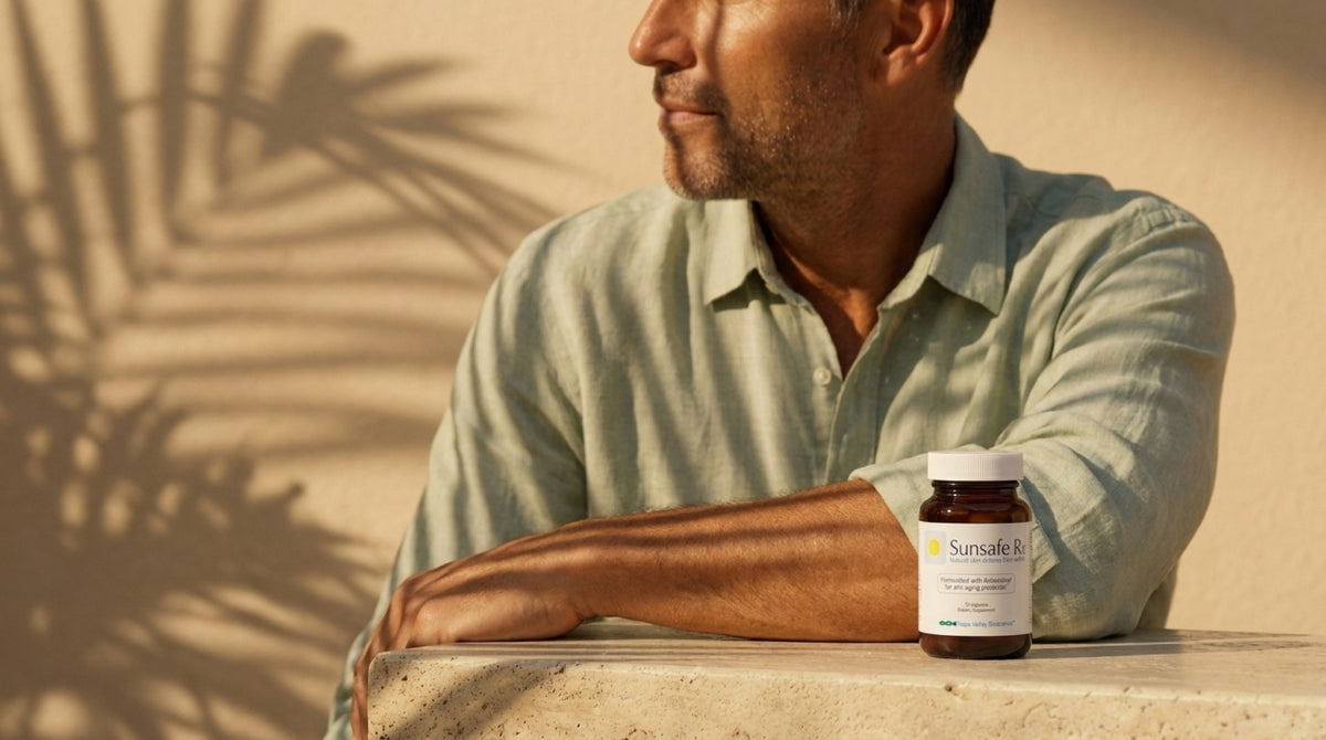 A man's shoulder and forearm in low golden light with palm-leaf shadows, a Sunsafe Rx bottle on the ledge